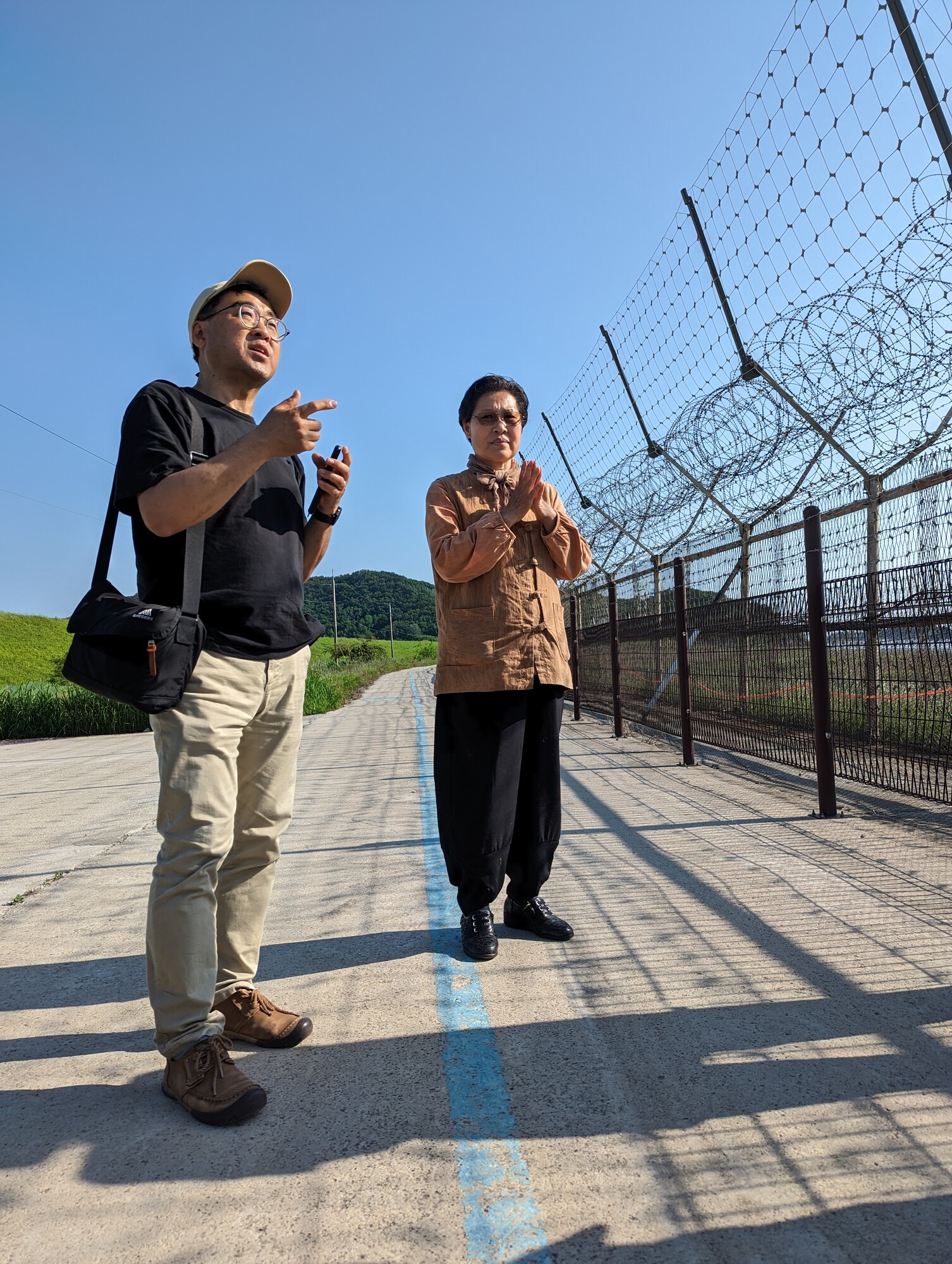 Mennonite Central Committee (MCC) Northeast Asia representative SeongHan Kim, left, and Gyodong Island peace worker Kim Young-Ae are on the South Korean island’s shore, about a mile from North Korea
